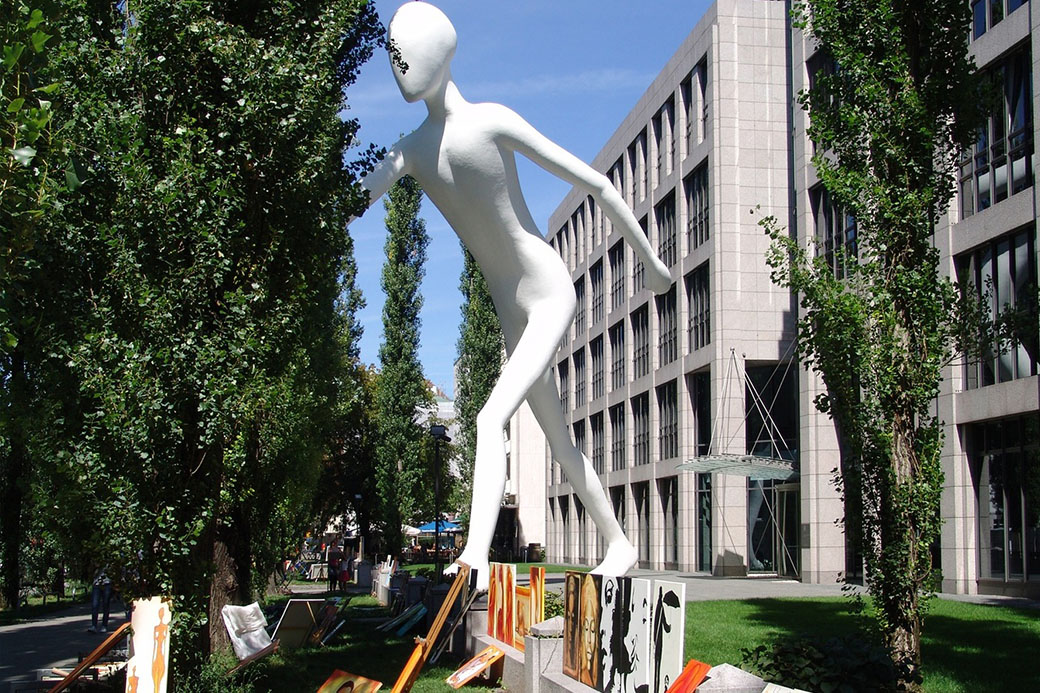 Walking Man, Sculpture by Jonathan Borofsky in glassfibre reinforced plastic 17 meter high, since 1995 in front of the building of the Versicherung Munich Re in Leopoldstrasse, Munich, Bavaria, Germany, Europe.